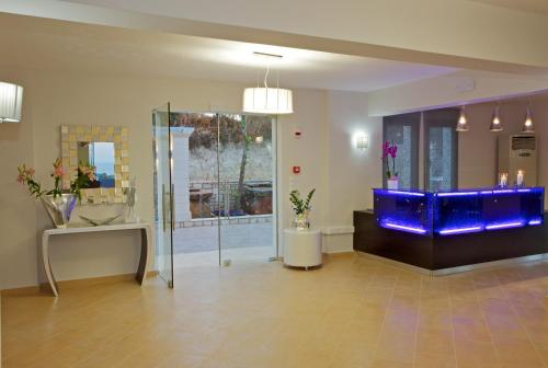 a lobby with a blue aquarium in a room at Carme Villas in Adelianos Kampos