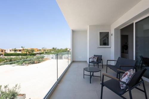 an apartment balcony with a view of a patio at Dara Holiday Apartments in Marsala