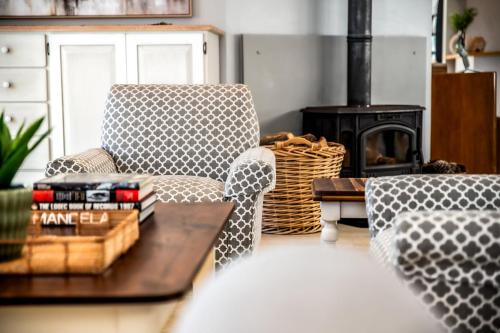 a living room with two chairs and a coffee table at Whale Coast Ocean Villa in Hermanus