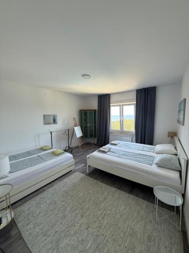 a bedroom with two beds and a window at Holiday Home Oliva in Novalja