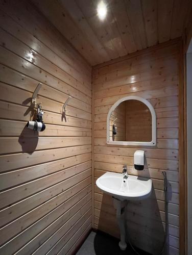 a bathroom with a sink and a mirror at Motelli Rovaniemi in Rovaniemi