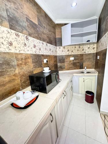 a kitchen with a microwave on a counter at Lake 47 Suites Ltd in Abuja