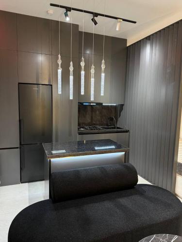 una cocina con encimera negra y una isla negra en Golden House Luxury, en Toshkent-Passajir Bekati