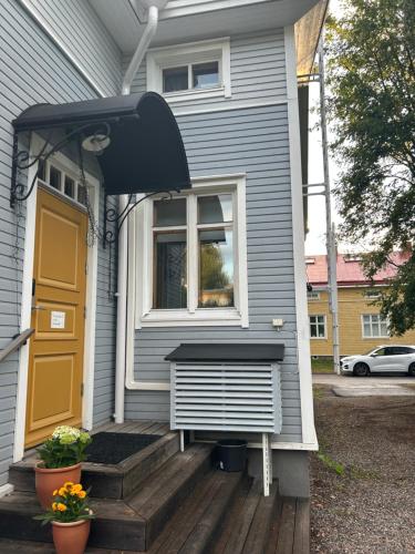 a house with a bench on the front porch at Cozy 1 Br Apt and Free parking by the Railway station in Oulu