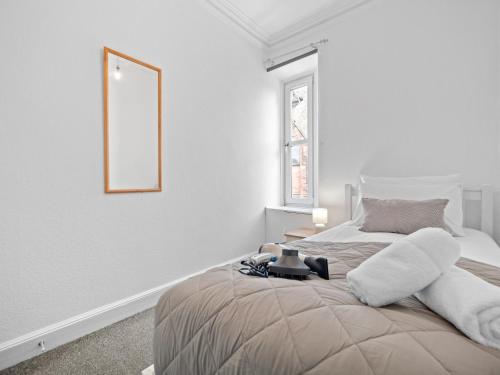 a white bedroom with a bed and a mirror at Ludgate 2 Bedroom Apartment - Alloa in Alloa