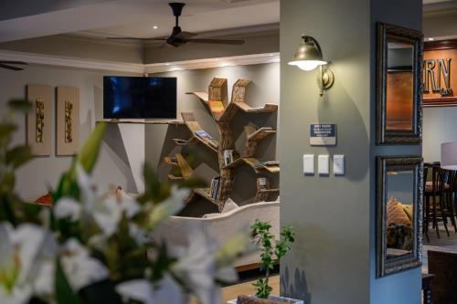 a room with a tree shelf on the wall at Umthunzi Hotel and Conference in Umtentweni