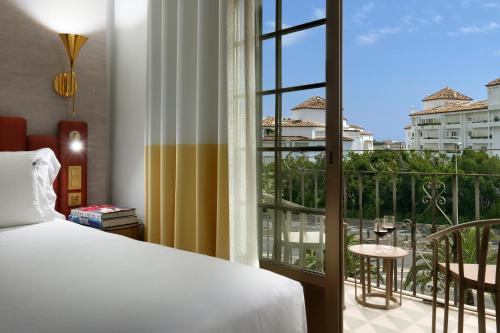 a hotel room with a bed and a balcony at Hard Rock Hotel Marbella - Puerto Banús in Marbella
