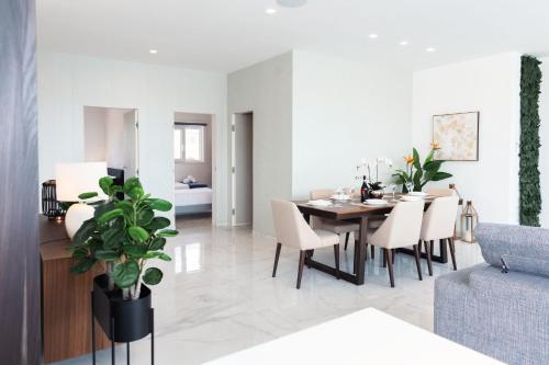 a dining room and living room with a table and chairs at Villa Ixoria Unit 1 with Private Pool by ArcoCollection in St. Julianʼs