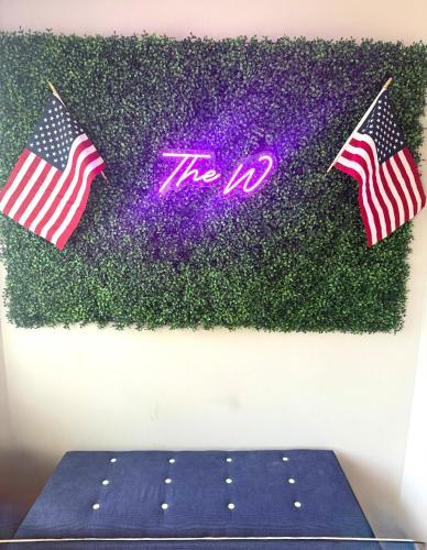 a sign that reads the iv with two american flags at coastal and cozy beach stay, pet friendly in Milford