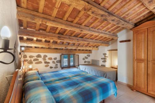 Sant Iscle de VallaltaにあるCan Rocosaの木製の天井の部屋にあるベッドのある寝室