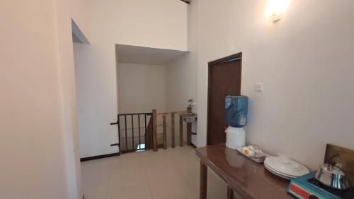 a room with a table and a room with a door at Kumara Guest House in Anuradhapura