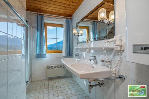 a bathroom with a sink and a mirror at Appartements Spitzegel in Hermagor