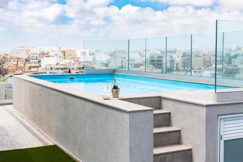 a swimming pool on the roof of a building at Villa Ixoria Unit 2 w Rooftop Pool by Arco Collection in St. Julianʼs
