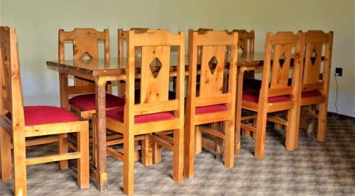 a wooden dining room table with chairs and a table and chairsktop at ANCIENT STAY by MANOKUR- E- BASA in Minapin