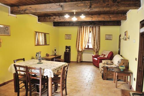 a living room with a table and a couch at Country House Federico I in Sassoferrato