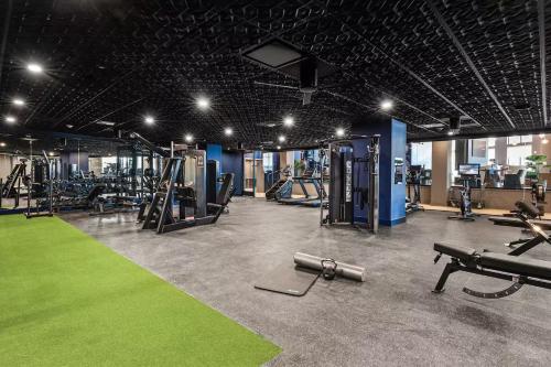 a gym with several treadmills and machines in it at Luxury Apartments by Hyatus White Plains in White Plains