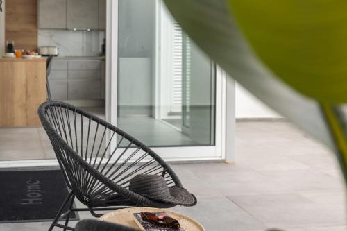 a black chair with a hat and a table at Casa Branca 36 by An Island Apart in Funchal