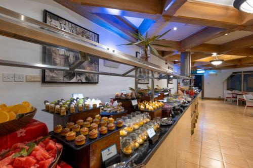 a buffet line with food on display in a store at Atana Khasab Hotel in Khasab