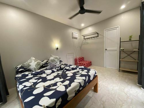 a bedroom with a bed and a ceiling fan at Tatay Noel Farm house in El Nido