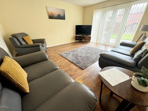 a living room with a couch and a table at Family home close to Shrewsbury Town centre in Shrewsbury