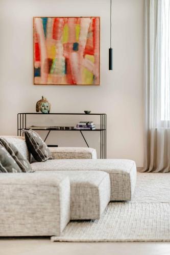 a living room with two beds and a couch at Mondellebotte - Luxus Villa & traumhafter Meerblick in Barat