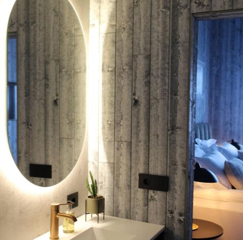 a bathroom with a sink and a mirror at Bakkabyggd - A lake view villa in Ólafsfjörður