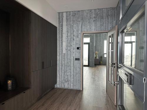 a hallway with a door leading to a room at Bakkabyggd - A lake view villa in Ólafsfjörður