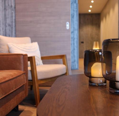a living room with a table and chairs and a couch at Bakkabyggd - A lake view villa in Ólafsfjörður