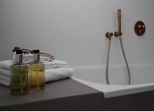 a bathroom with two bottles of soap and a bath tub at Bakkabyggd - A lake view villa in Ólafsfjörður