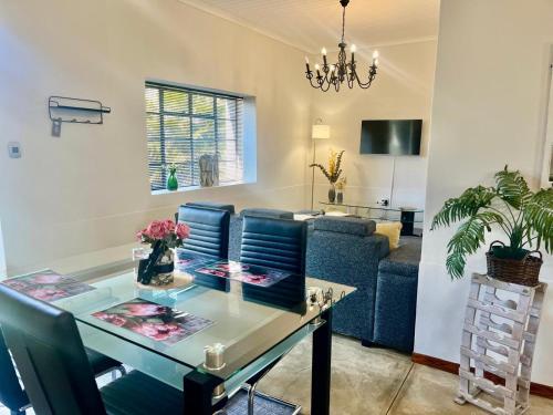 a living room with a blue couch and a table at Hephzibah Inn Signature Farm Cottage in Hermon