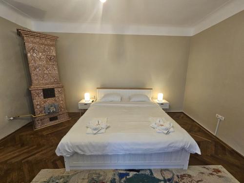 a bedroom with a bed with two candles on it at Honterus Apartments I by Kronstay in Braşov