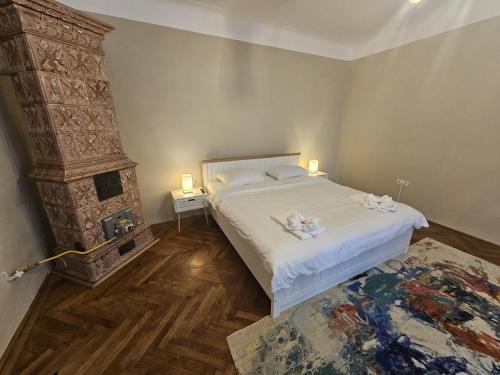 a bedroom with a large bed and a fireplace at Honterus Apartments I by Kronstay in Braşov
