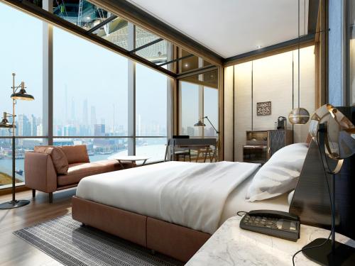 a bedroom with a large bed and a large window at Thompson Shanghai Expo in Shanghai