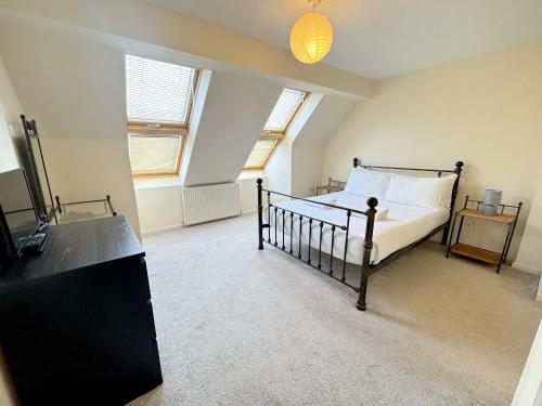 a bedroom with a bed and a tv in it at Family home close to Shrewsbury Town centre in Shrewsbury