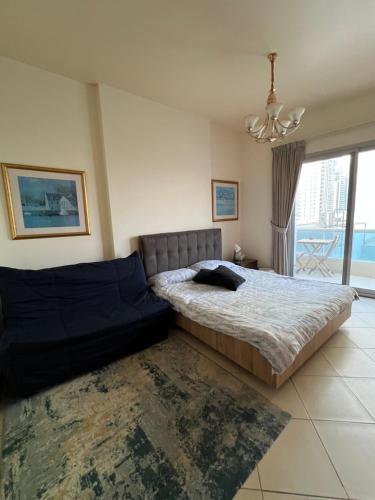 a bedroom with a large bed and a chandelier at Marina Diamond in Dubai