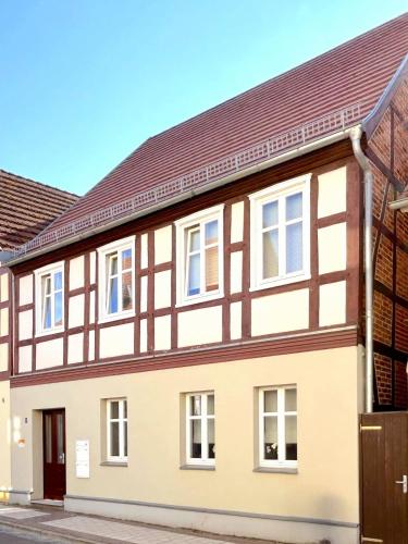 a large house with a brown roof at Mühlenloge 1819 in Perleberg