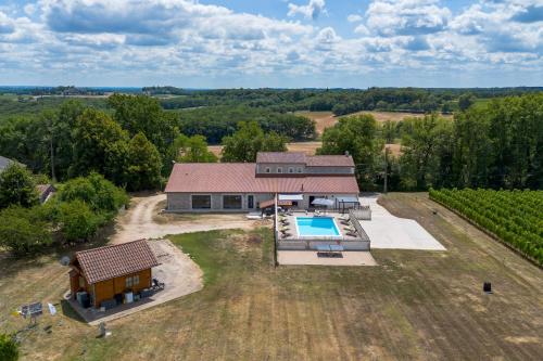 une vue aérienne d'une maison avec piscine dans l'établissement Le Chai Villa, à Thénac