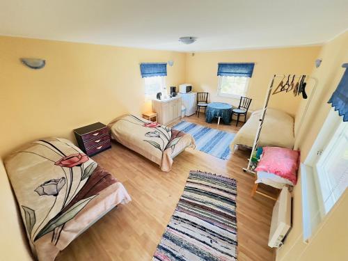a living room with two beds and a table at Roosi Camping Houses in Rannaküla