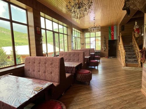a lobby with couches and chairs and a chandelier at Shahdag Boutique Hotel in Laza