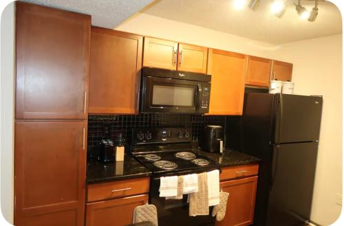 a kitchen with a stove and a microwave and a refrigerator at Home Away From Home in Marietta