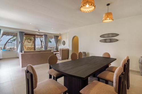 a dining room and living room with a table and chairs at Kiwengwa Beach Resort in Kiwengwa