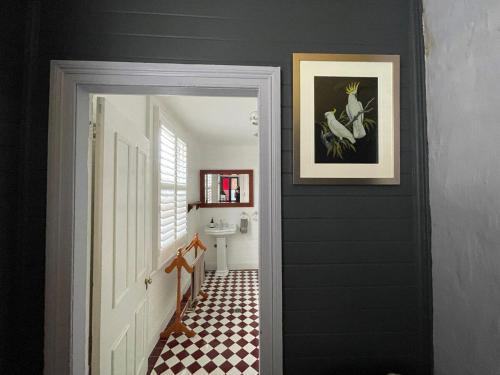 a hallway with a black wall and a white door at Kedumba Cottage: Gorgeous Home 2 Min Walk to Town in Katoomba