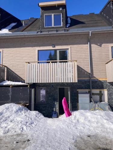 a pile of snow in front of a house at Kåvan Townhouse Funäsdalen in Funäsdalen