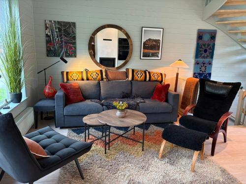 a living room with a couch and chairs and a table at Kåvan Townhouse Funäsdalen in Funäsdalen