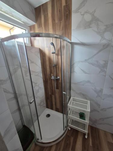 a shower with a glass enclosure in a bathroom at Willa Elżbieta in Rewal