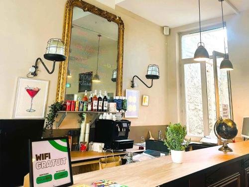 a bar with a mirror and a counter in a room at Auberge de jeunesse HI Avignon in Avignon