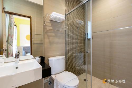 a bathroom with a toilet and a sink and a shower at 家家嵐玥 in Toucheng