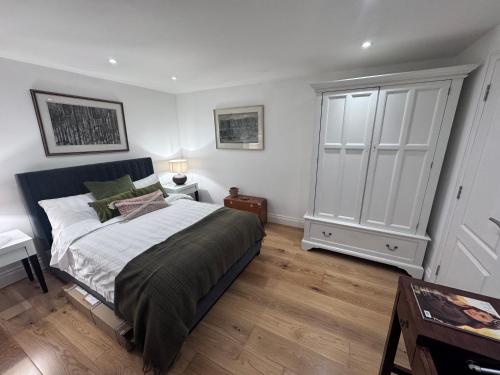 a bedroom with a large bed and a dresser at Regency Haven in London