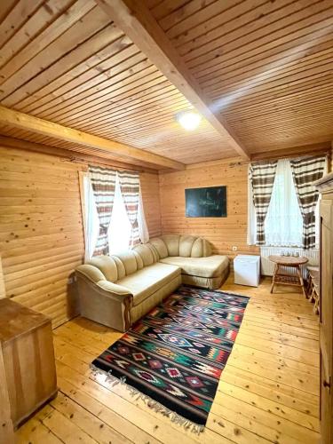 a living room with a couch and a rug at Готель Пацьорка in Kremintsi