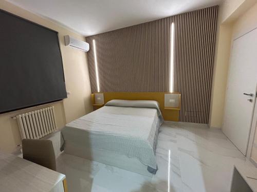 a bedroom with a bed and a flat screen tv at L Oasi di Lauria in Lauria